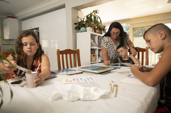Sara Taylor home schooling her children  Genevieve, 9, Alexander, 6, and Sebastian, 11.