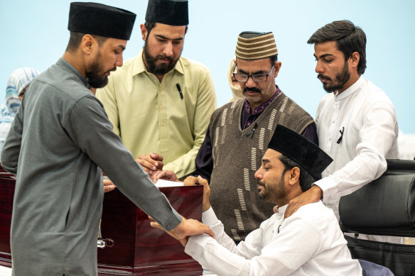 Brothers, uncle and nephew of Faraz Tahir view his body and say farewell at his funeral today.