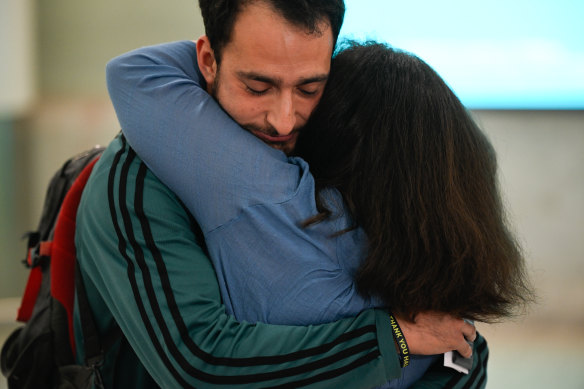 Travellers are reunited with family as they arrive at Sydney Airport from Israel via Dubai on a government assisted Qatar flight QR7424.