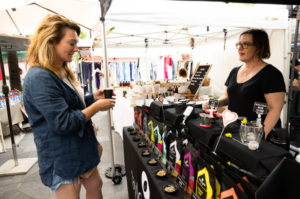 Karen Taylor, right, hands out tea samples at Double Bay markets.