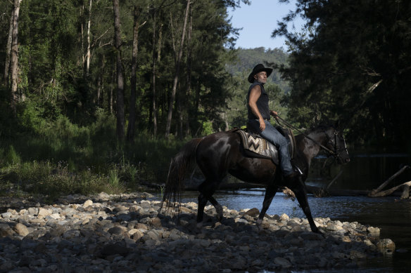 Chris Fenech, from HWH Stables, takes visitors on rainforest horse rides in Upper Orara along the Urumbilum River.