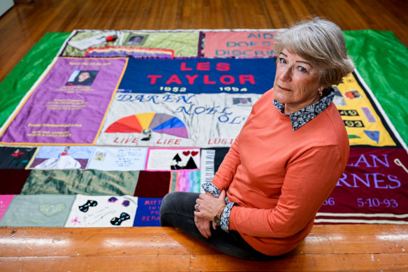 Cheryl Olver in front of the quilt panel she lovingly made for her son Daren after he died from an AIDS-related illness in 1994.
