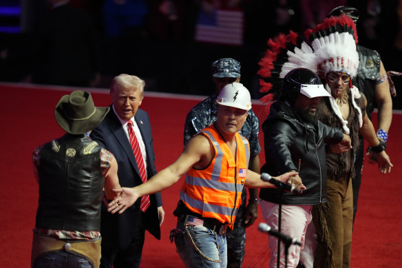 President-elect Donald Trump, second left, greets members of the Village People.