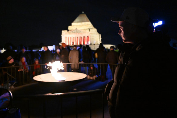 People stand by the eternal flame.