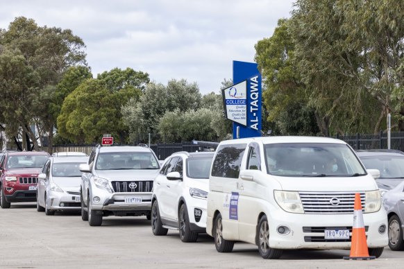 Cars queue at the pop-up testing clinic at Al-Taqwa College on Thursday morning. Eligible candidates are also being offered a dose of the Pfizer COVID-19 vaccine. 