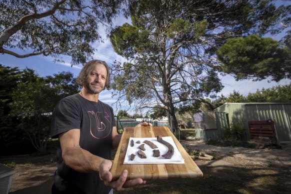 Kevin Neville with horse artefacts found under an old tree he believes is the burial site of former racehorses and broodmares from stables with links to Phar Lap.