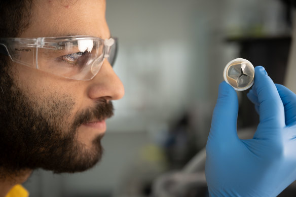 Dr Sepehr Talebian with an artificial heart valve developed by biochemical engineers at the University of Sydney.