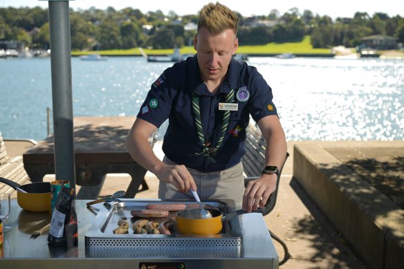 The new Scout NSW Chief Commissioner Lloyd Nurthen encourages the sausages to sizzle. 