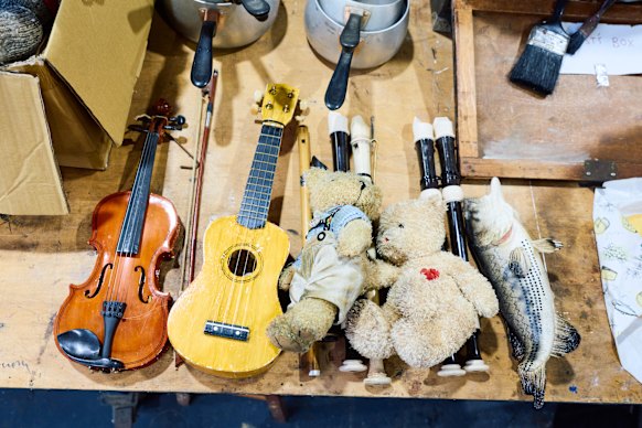 Props line the benches inside Opera Australia’s workshop during the design process for La Boheme.