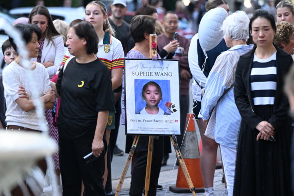 People are seen during a vigil for schoolgirl Sophie Wang at Emerald Lakes on the Gold Coast.