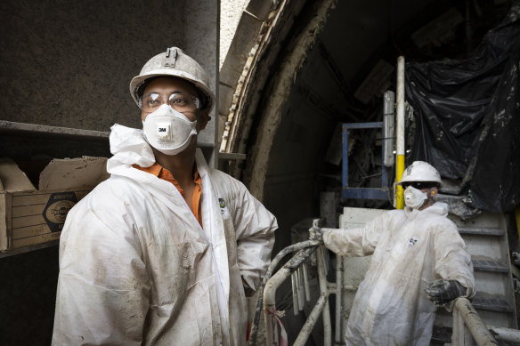 Tai Maxwell, left, is working on one of the boring machines for the airport line project.