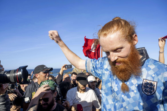 Russ Cook celebrates with supporters after arriving at the northern tip of Africa.