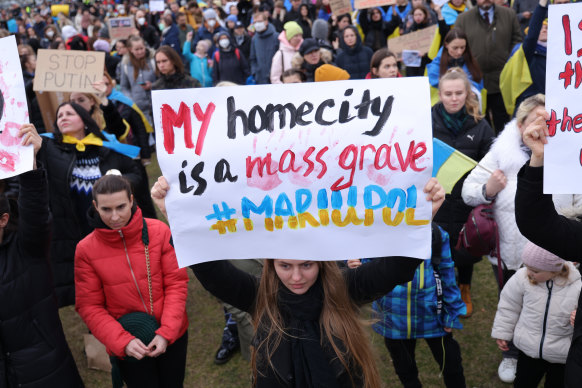 A protester holds a sign referring to the war-battered Ukrainian city of Mariupol during a demonstration against the Russian military invasion of Ukraine in Berlin, Germany.