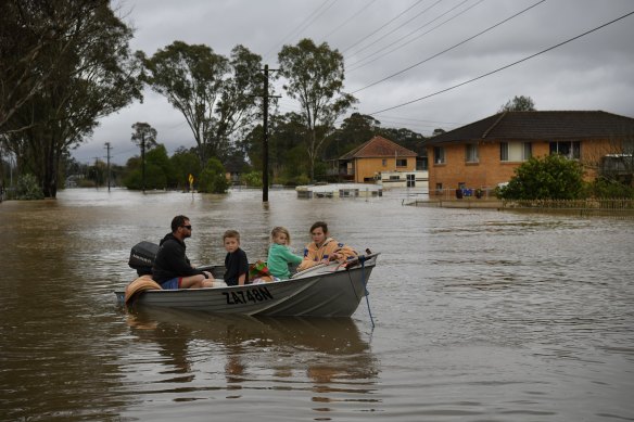 A family evacuates in Shanes Park, Sydney. 