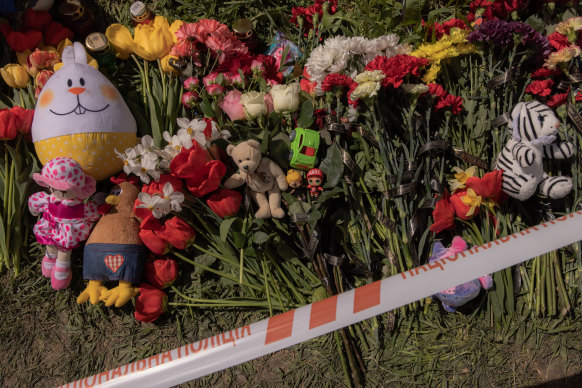 Flowers and toys left by people in memory of the victims lay at the site of the destroyed residential building that was hit during the Russian attack, on April 29, 2023 in Uman, Ukraine.