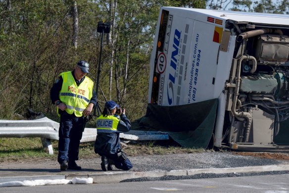 Police investigate at the scene of the fatal bus crash on Monday afternoon.