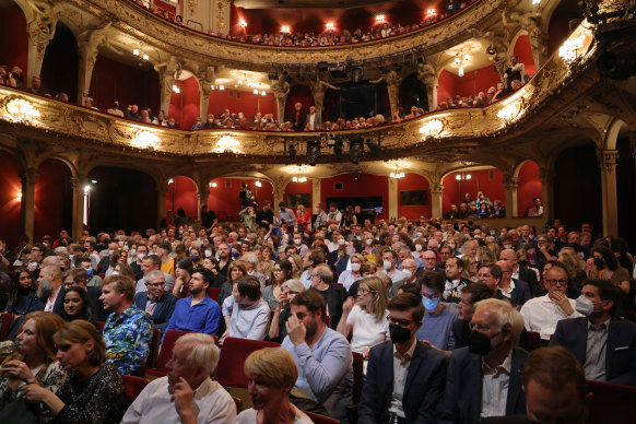 Members of the audience wait to witness former German Chancellor Angela Merkel in conversation with journalist Alexander Osang on stage at the Berliner Ensemble theatre. 