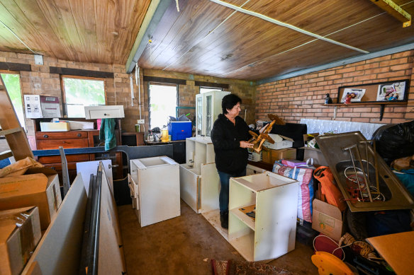 McBride goes through belongings in her flood-damaged home.