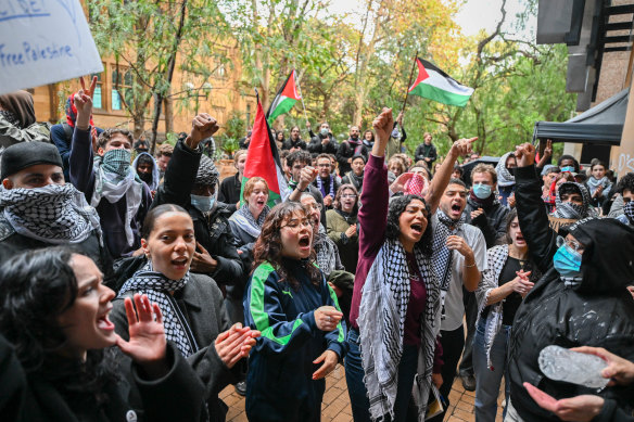 Students rally outside the university’s Arts West building in May.