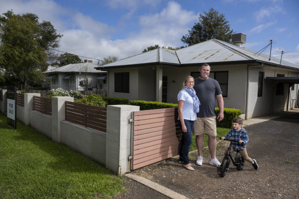 Adam and Leanne Neil, with son Isaac, outside their new Gunnedah home, which they recently purchased with a government guarantee scheme.