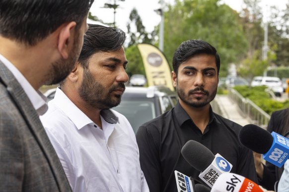 Brothers of Faraz Tahir, the security guard who was murdered by Joel Cauchi, speak outside the NSW Coroners Court on Tuesday.