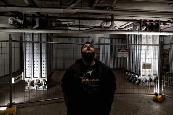 Apartment owner Patrick Quintal in front of the two structural columns installed in the basement of the Canterbury tower.