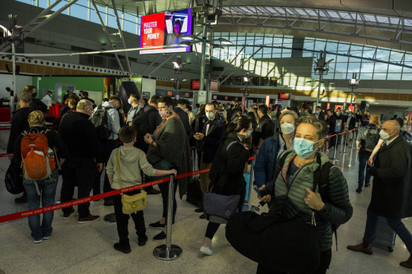 Qantas passengers queue at the security check-in at the Qantas domestic terminal in Sydney on Friday.