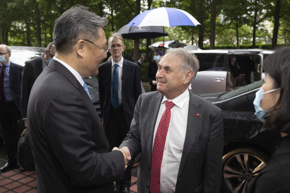 Trade Minister Don Farrell greeting Commerce Minister Wang Wentao during a trip to Beijing in May.