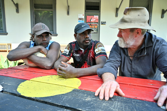 Tashiem (left) and Tyler Abbott chat with Barry Watts who was with them on the camel trek.