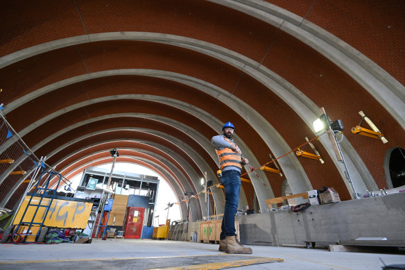 A construction worker inside the entrance to Arden station. 