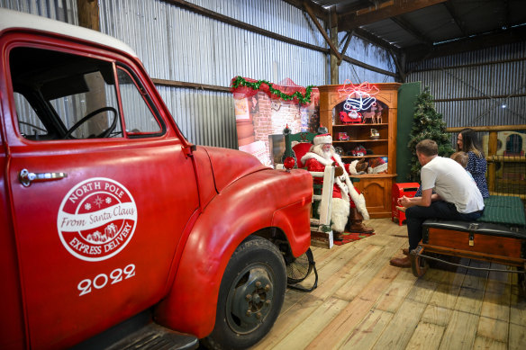 A family is ready for its closeup with Aussie Santa. 