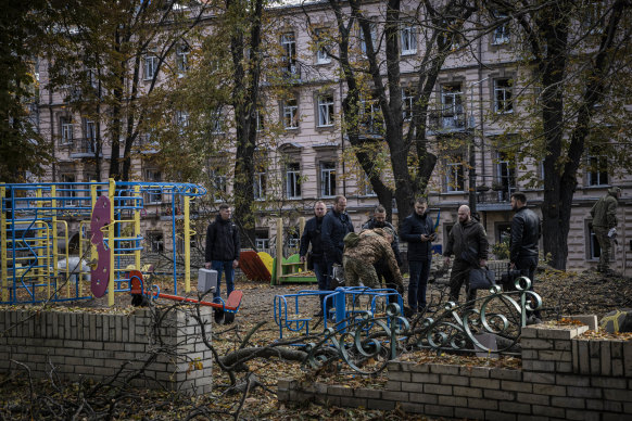 Emergency service personnel attend to the site of a blast next to a children’s playground.