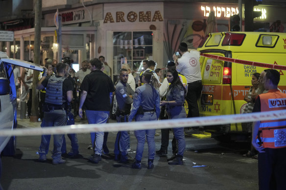 Israeli police and first responders gather at the scene of a deadly explosion in Tel Aviv.