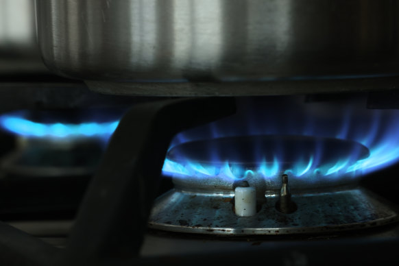 A gas flame burns under a pot on a stove top in Berlin, Germany. 