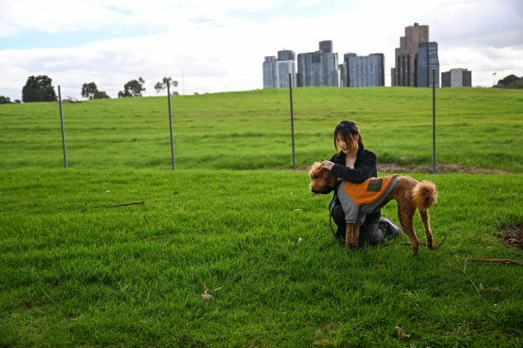 Vivy Li stands outside the Old Box Hill Brickworks site with her dog, Leo.