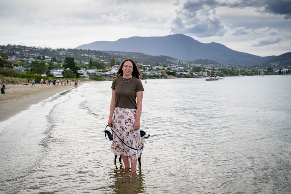 Jessie Bodor, pictured with her dog George at Nutgrove Beach, Sandy Bay, in Hobart, moved south as Sydney’s summers grew hotter.
