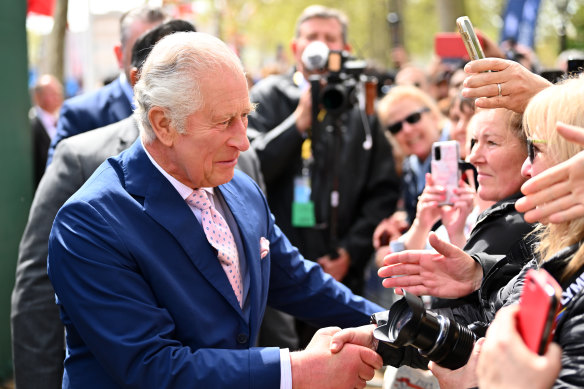 King Charles III greets members of the public along the Mall as preparations continue ahead of the Coronation of King Charles III and Queen Camilla on May 05, 2023 in London, England.