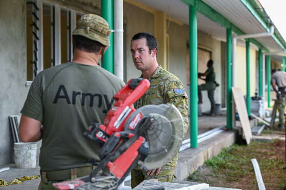 Army Captain Brenton Cathie in the Lekutu Secondary School Australia is helping to build.