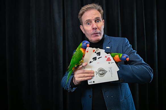 Magician Tim Ellis with his lorikeets.