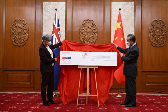 Penny Wong was presented with a giant commemorative envelope during a ceremony to mark the 50th anniversary of diplomatic relations between Australia and China. 