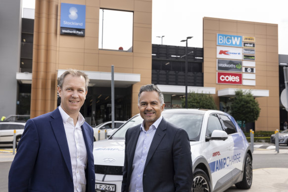 Ampol CEO Matt Halliday (left) and Stockland CEO Tarun Gupta (right) at Stockland Wetherill Park with new the  AmpCharge fast charging bay
