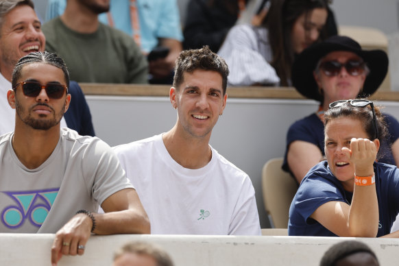 Australia’s Thanasi Kokkinakis watches fellow countryman Alex de Minaur in the fourth round at the French Open.