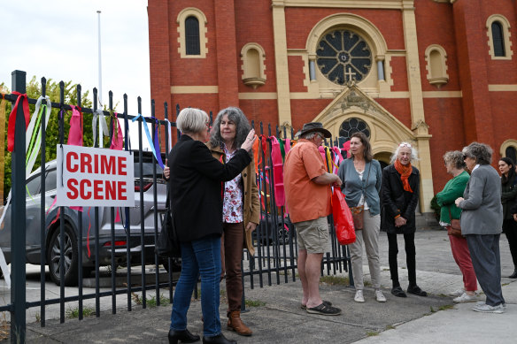 Supporters gather outside Sacred Heart Church in Oakleigh. 