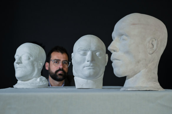 Curator Rohan Long with the death masks (from left) of bushrangers Dan Morgan and Ned Kelly, and killer John Weechurch.
