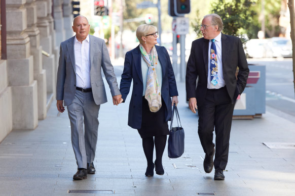 Former minister Linda Reynolds arrives at the Perth Supreme Court in March for a mediation session with Brittany Higgins, flanked by partner Robert Reid (left) and lawyer Martin Bennett. 