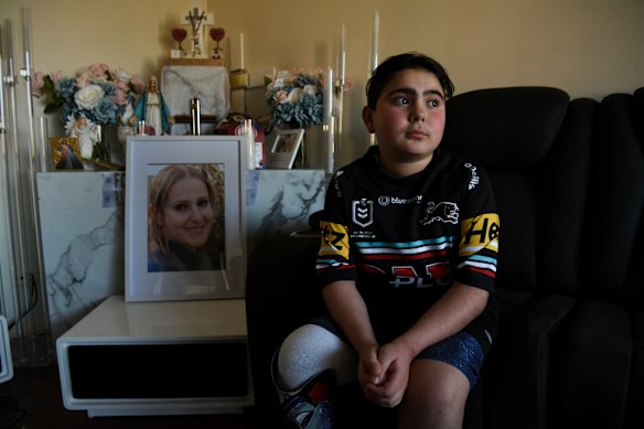 Sea World helicopter crash survivor Nicholas Tadros with a portrait of his late mother Vanessa. 
