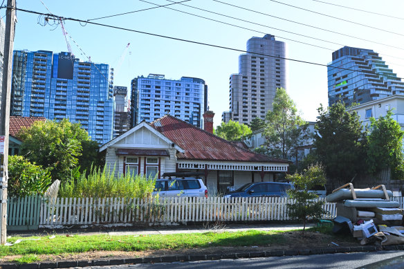 An old Box Hill weatherboard home is surrounded by high-rises.