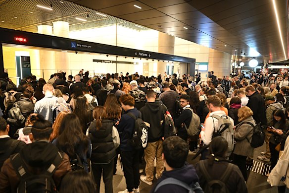 Passengers queue outside the Gadigal Metro Station.