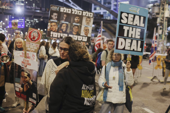 Protesters hug in response to reports of a ceasefire agreement during a protest calling for the release of the hostages in Gaza in Tel Aviv, on Wednesday, January 15, 2025.