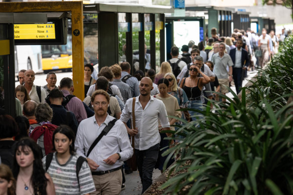 Commuters wait for buses outside Wynyard Station in the city.